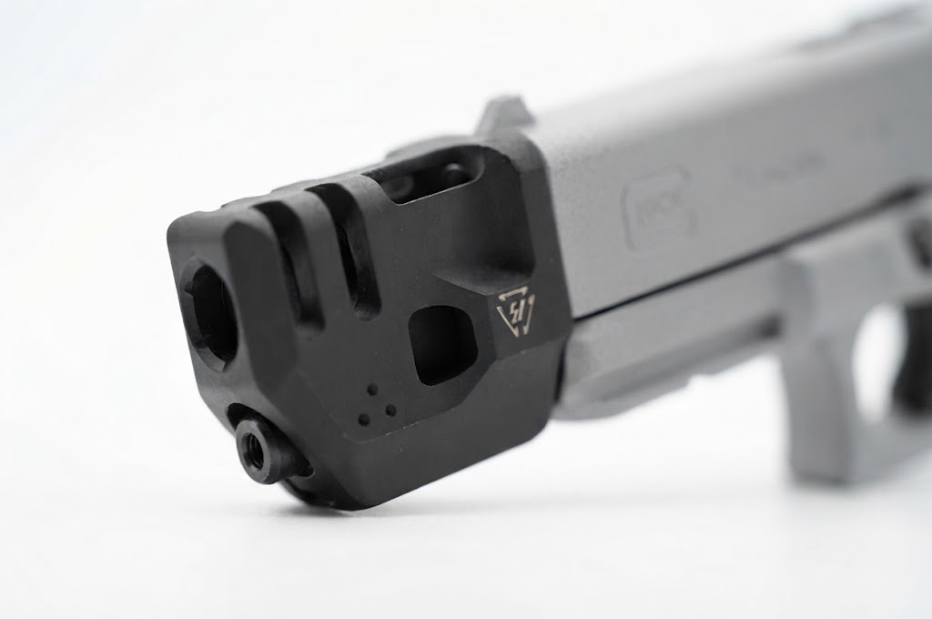 Compensador de pistola esportiva